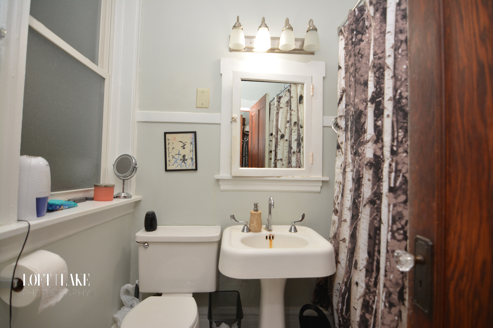 1609 West Grace Street, Unit 2 Chicago, IL 60613 - Photo 6 of 10 a bathroom with a sink mirror and toilet