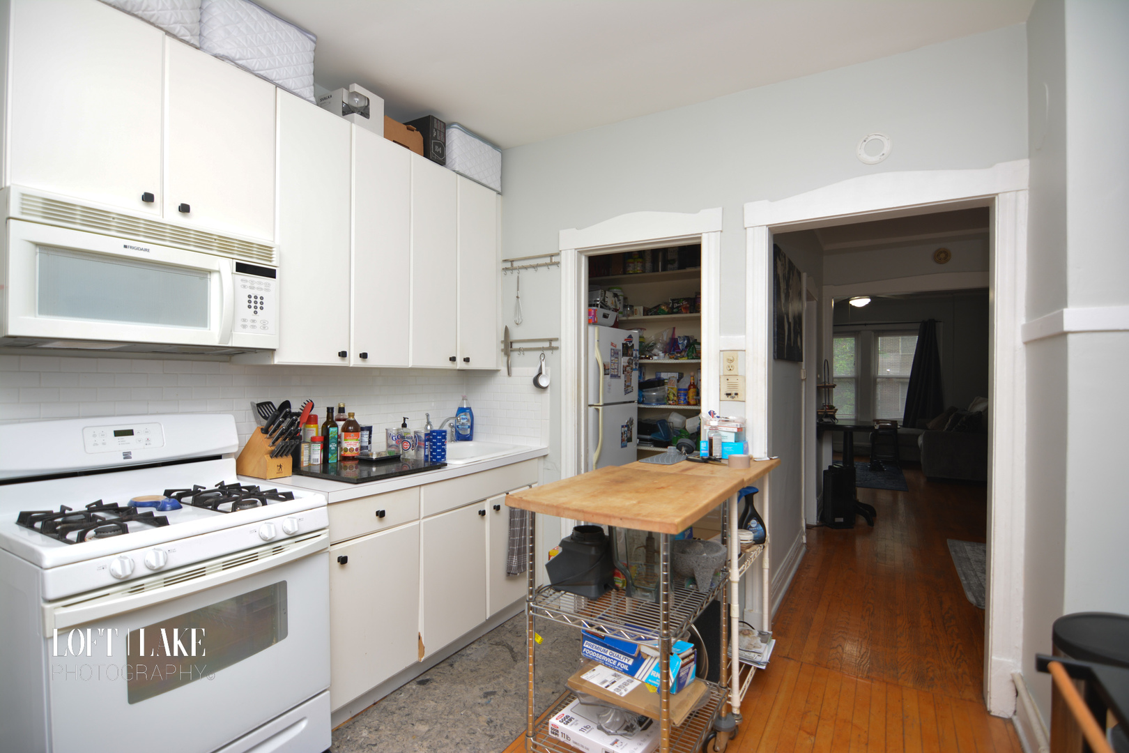 1609 West Grace Street, Unit 2 Chicago, IL 60613 - Photo 8 of 10 a kitchen with a stove a sink and a refrigerator