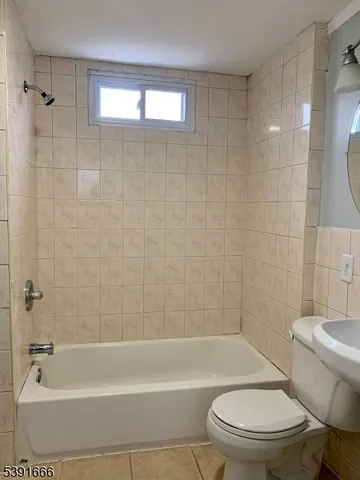 a bathroom with a bathtub toilet and shower