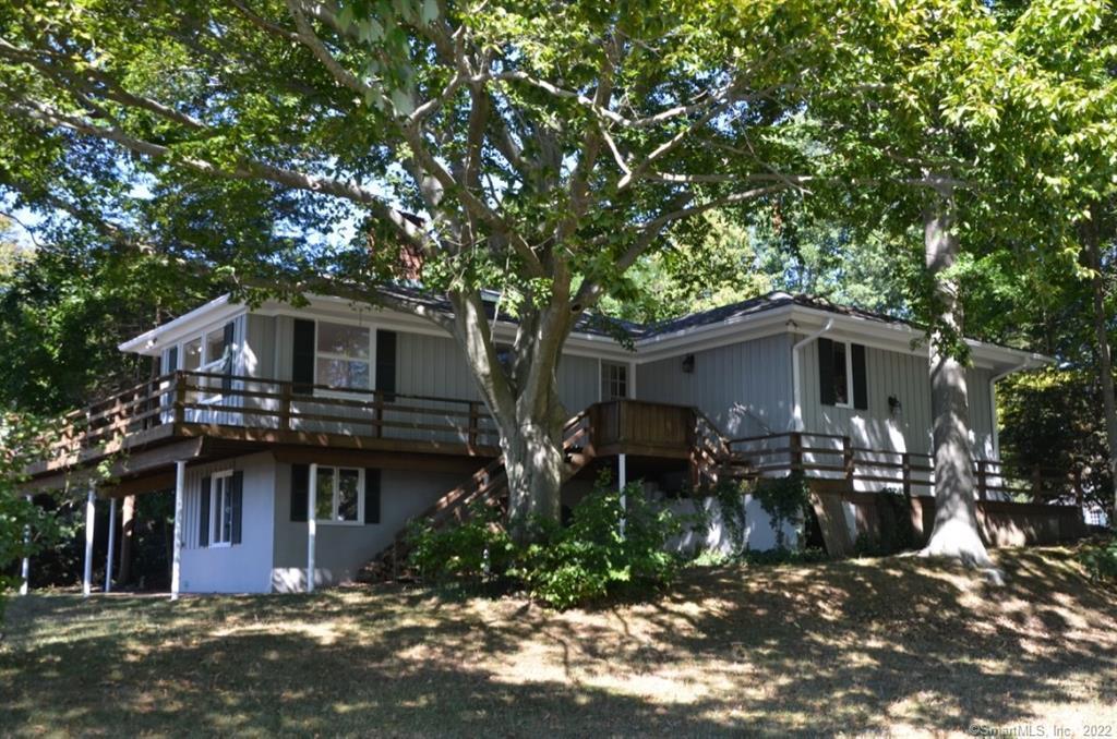 10 Seagate Road Darien, CT 06820 - Photo 1 of 1 a front view of house with yard and trees around