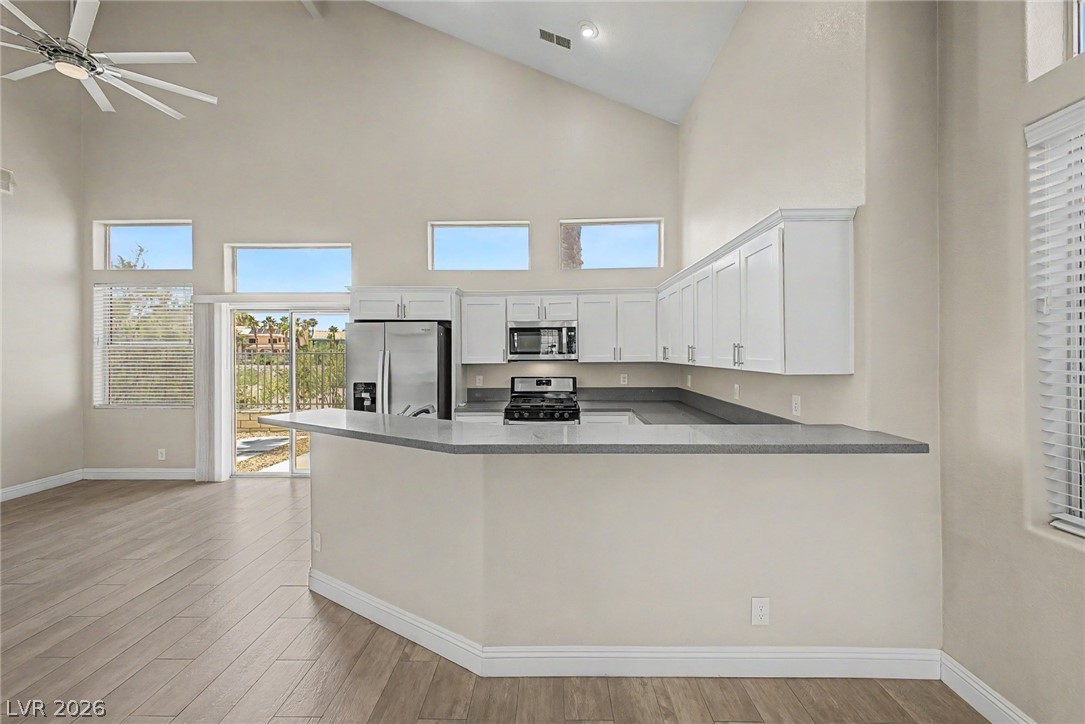 2316 Ramsgate Drive Henderson, NV 89074 - Photo 10 of 28 Prepare meals in a kitchen featuring sleek countertops, modern appliances, and convenient open-concept living.