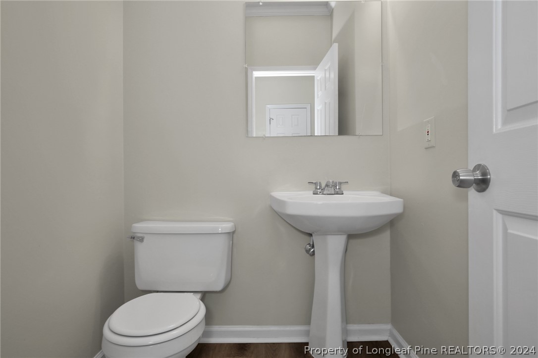 4780 Deer Lakes Road Fayetteville, NC 28311 - Photo 17 of 36 a bathroom with a sink a toilet and mirror