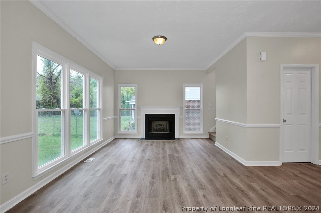 4780 Deer Lakes Road Fayetteville, NC 28311 - Photo 5 of 36 a view of an empty room with a window and wooden floor