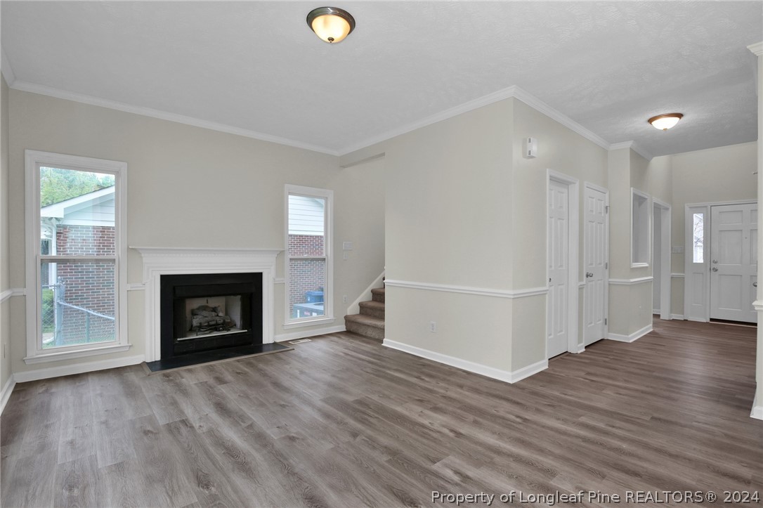 4780 Deer Lakes Road Fayetteville, NC 28311 - Photo 6 of 36 a view of a livingroom with wooden floor and a fireplace