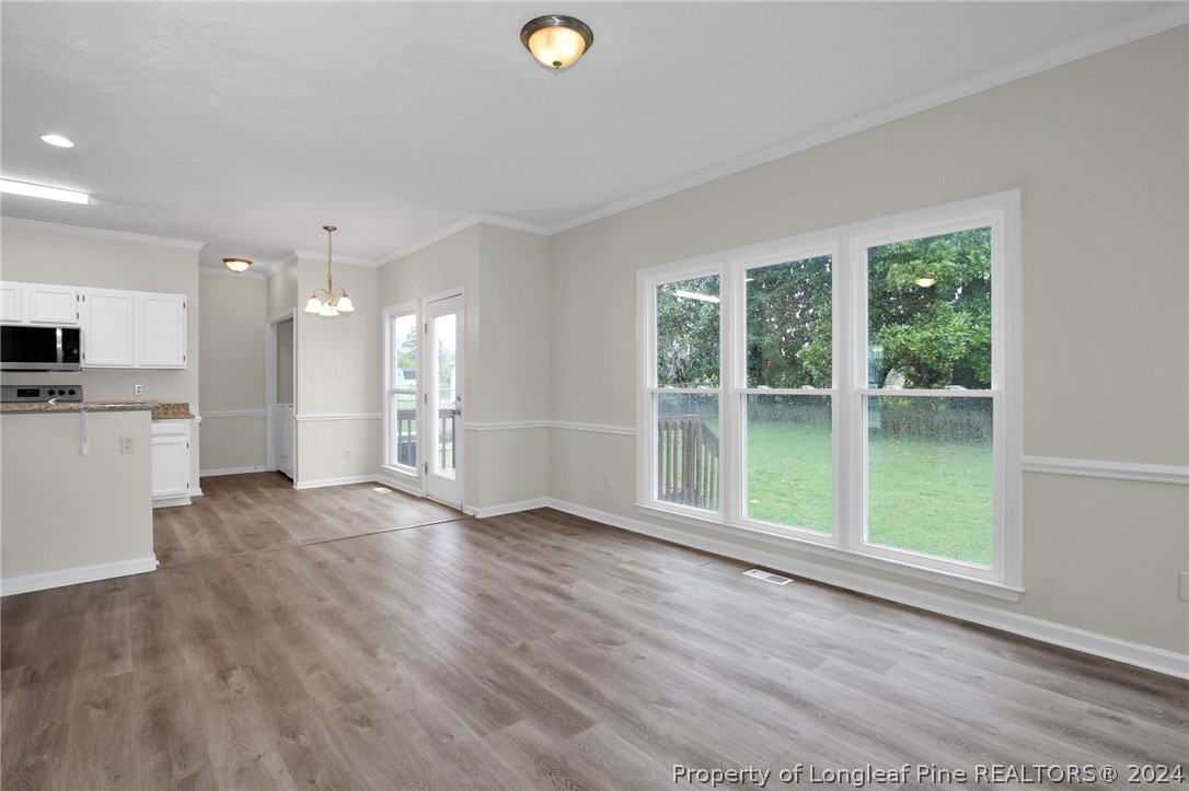 4780 Deer Lakes Road Fayetteville, NC 28311 - Photo 8 of 36 a view of an empty room with wooden floor and a window