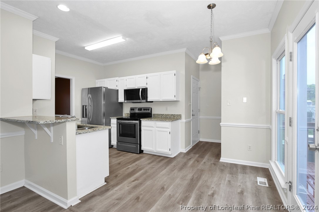 4780 Deer Lakes Road Fayetteville, NC 28311 - Photo 10 of 36 a kitchen with stainless steel appliances a refrigerator sink and microwave