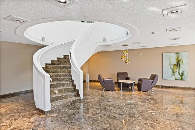 a living room with furniture a table and large windows