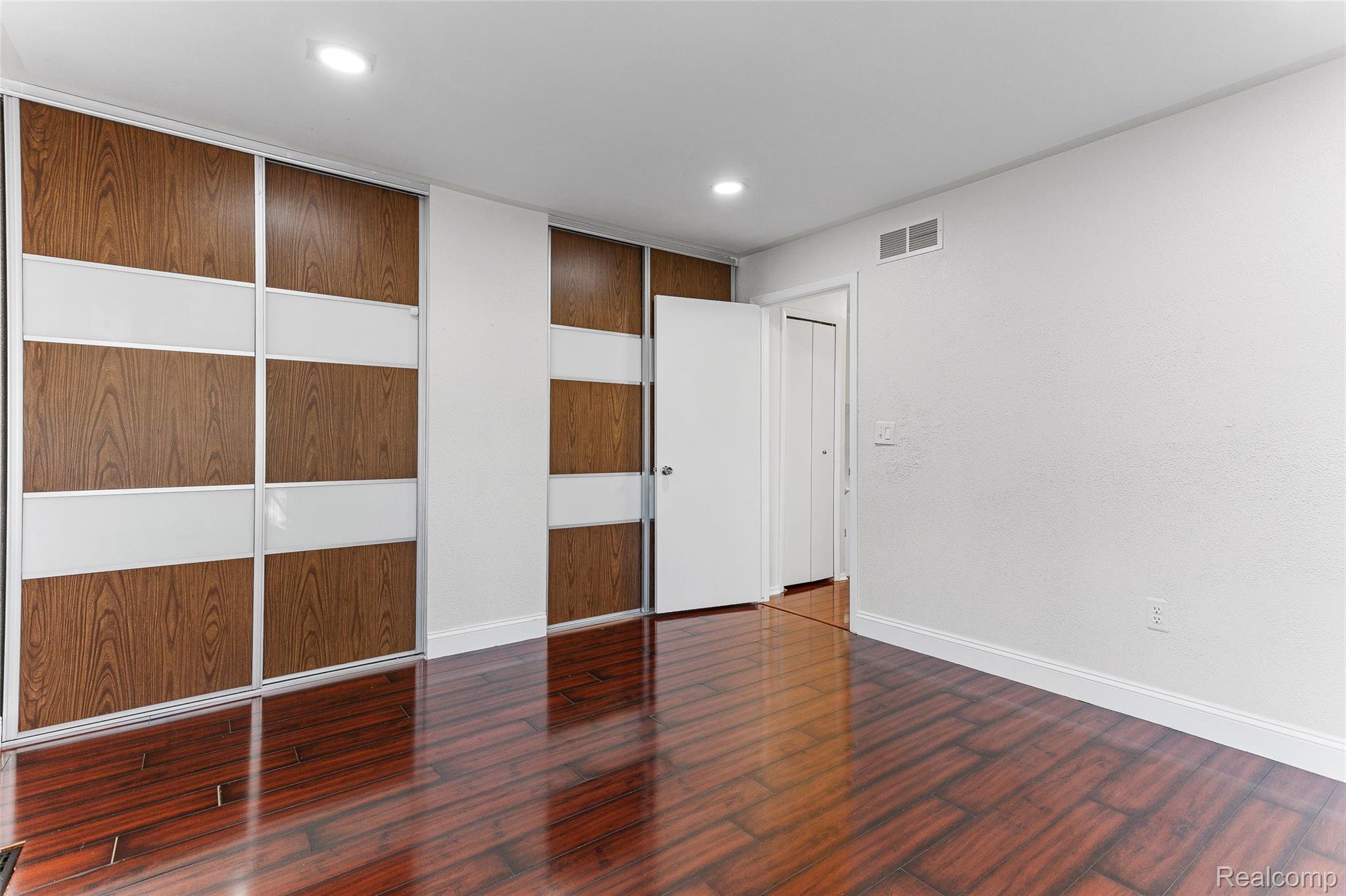 22582 Winfield Road Novi, MI 48375 - Photo 15 of 37 Reflective wood-finish flooring complements the white walls