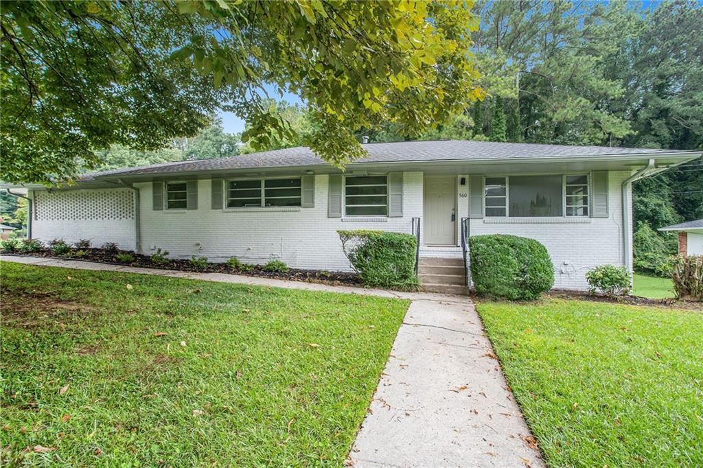 560 Lynn Valley Road Southwest Atlanta, GA 30311 - Photo 1 of 1 a front view of house with yard and green space