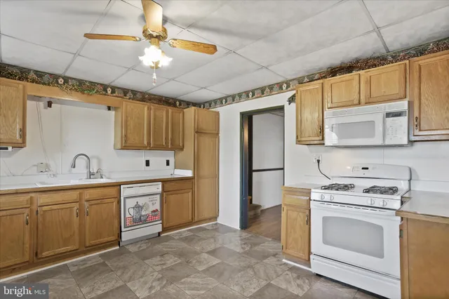 a kitchen with stainless steel appliances a stove sink and refrigerator