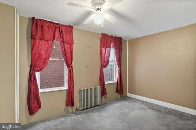 a view of a room with window and a ceiling fan