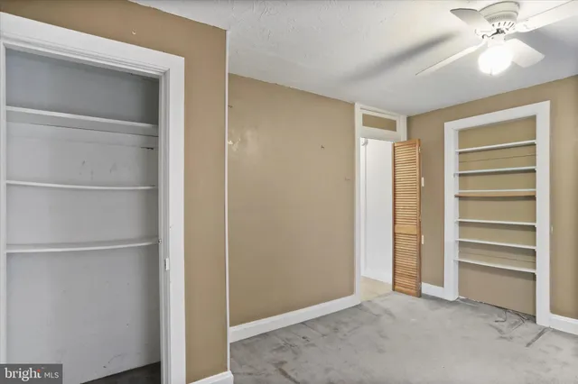 a view of an empty room with a closet