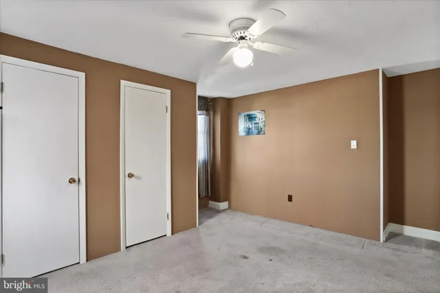 a view of an empty room with a ceiling fan