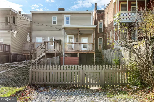 a view of a brick house with a small yard