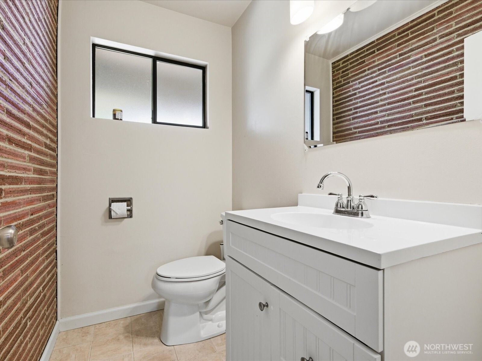 1417 Maple Street Sumner, WA 98390 - Photo 33 of 40 a bathroom with a sink a toilet and mirror