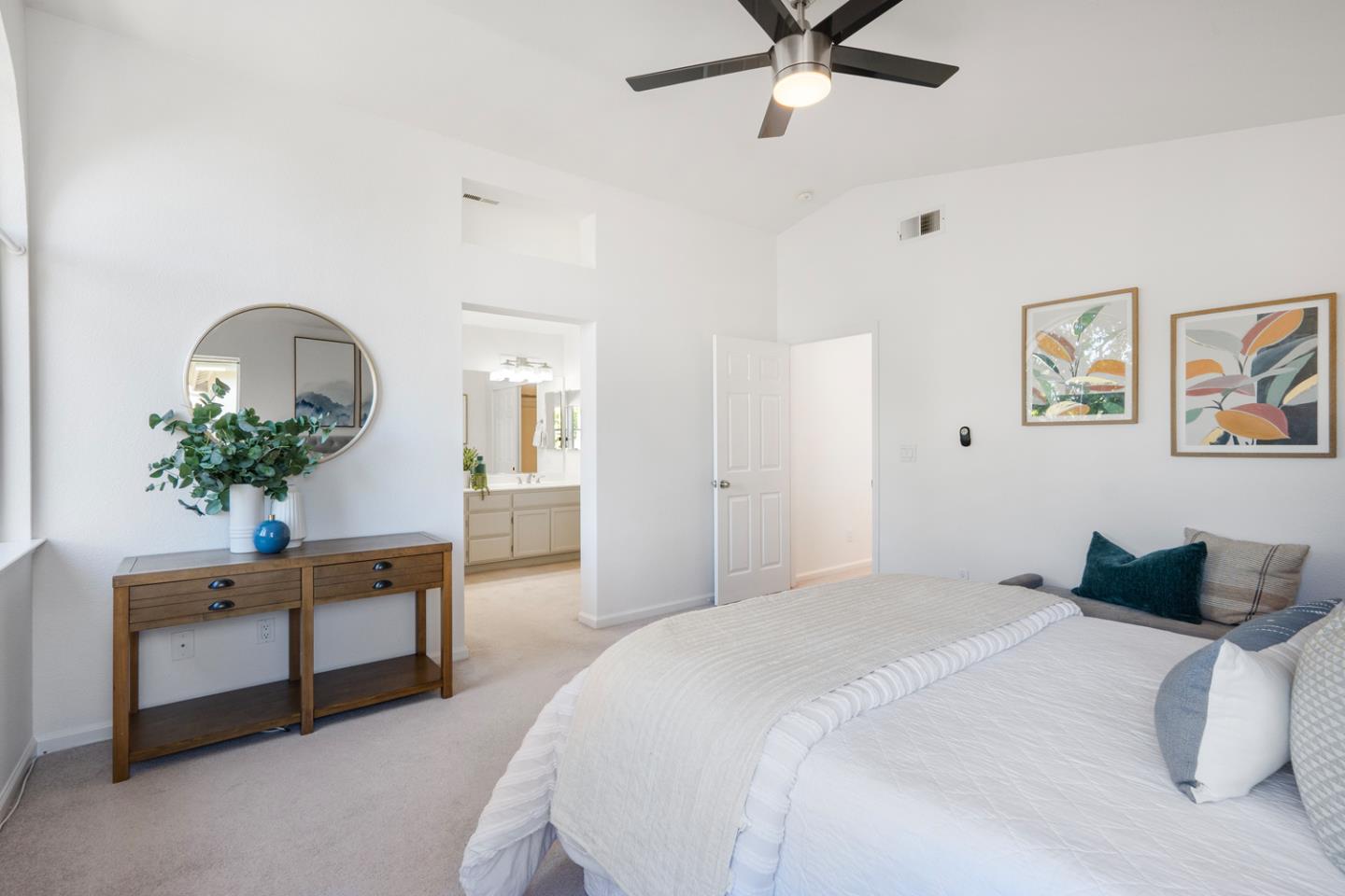 581 Eden Street Gilroy, CA 95020 - Photo 12 of 40 a bedroom with a bed table and a chandelier