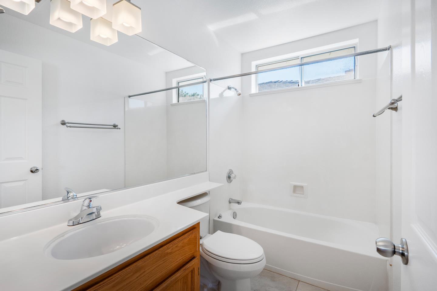 581 Eden Street Gilroy, CA 95020 - Photo 23 of 40 a bathroom with a sink toilet a mirror and shower