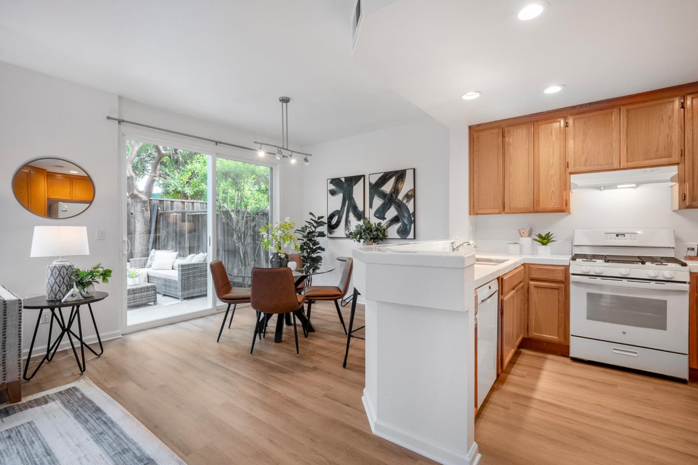 581 Eden Street Gilroy, CA 95020 - Photo 9 of 40 a kitchen with a table chairs stove and wooden floor