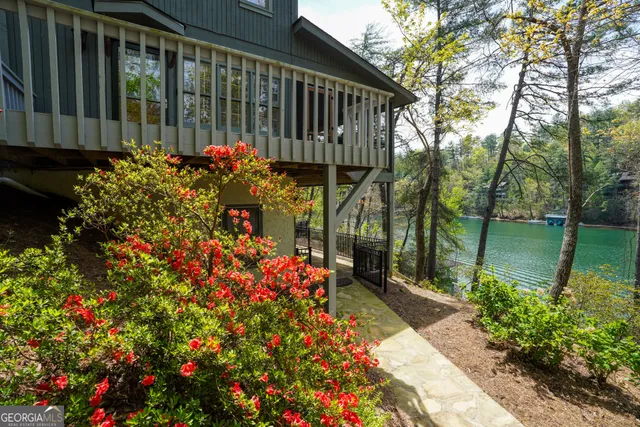 a view of a balcony with wooden floor and fence