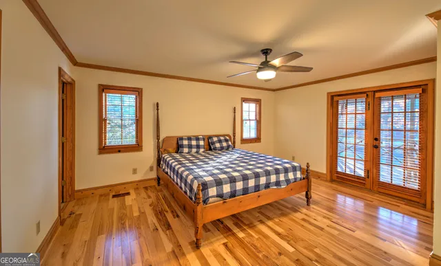a view of a livingroom with a chandelier fan and windows