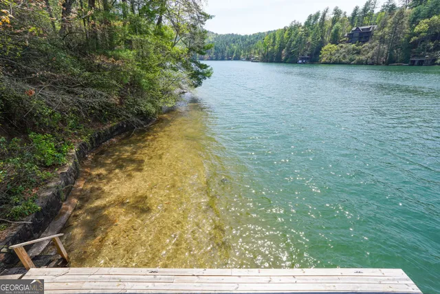 a view of a house with a yard and a sitting area