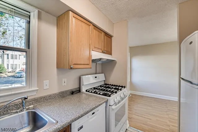 a bathroom with a sink vanity granite and toilet
