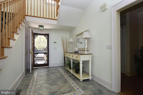 a kitchen with a table chairs refrigerator and cabinets