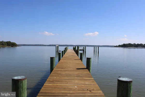 a view of swimming pool with outdoor seating and yard in back