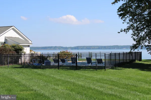a view of ocean with green space