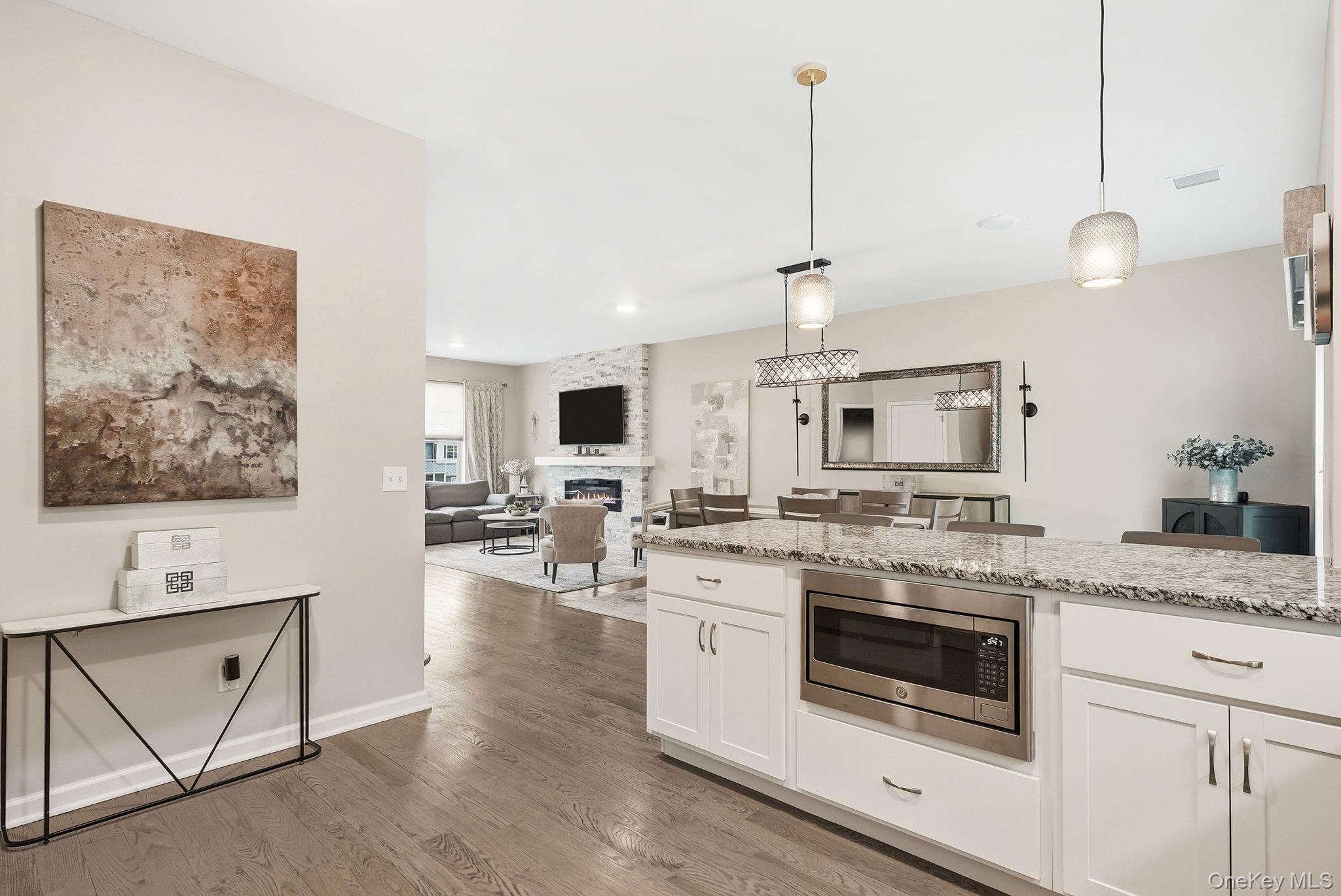8 Muscoot River Road Granite Springs, NY 10527 - Photo 14 of 40 Spacious kitchen island featuring a built-in stainless steel microwave, stone countertop, and white cabinetry