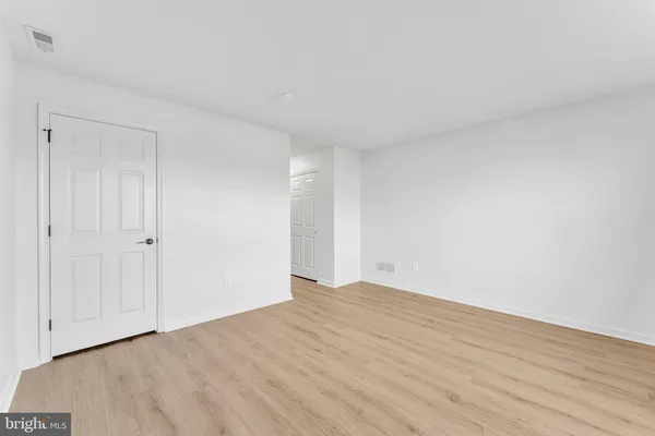 a view of an empty room and wooden floor