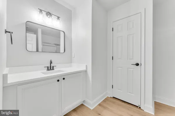 a bathroom with a sink a vanity and a mirror