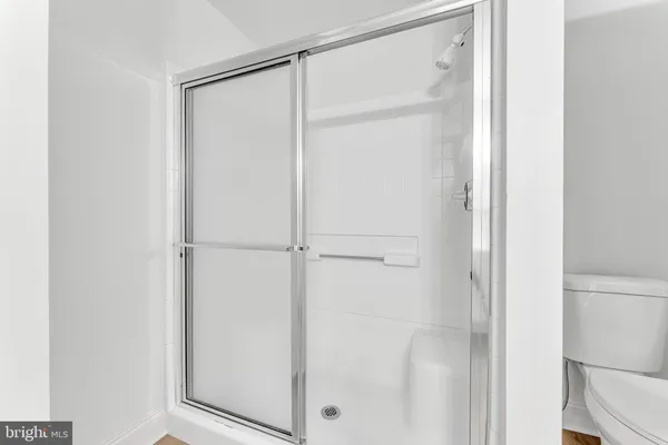 a bathroom with a glass shower door