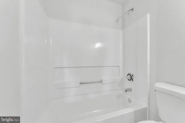 a bathroom with a bathtub and toilet