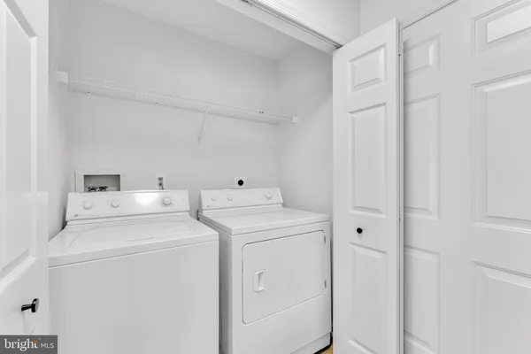 a view of storage and utility room with washer and dryer
