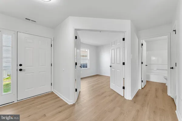a view of a hallway with wooden floor