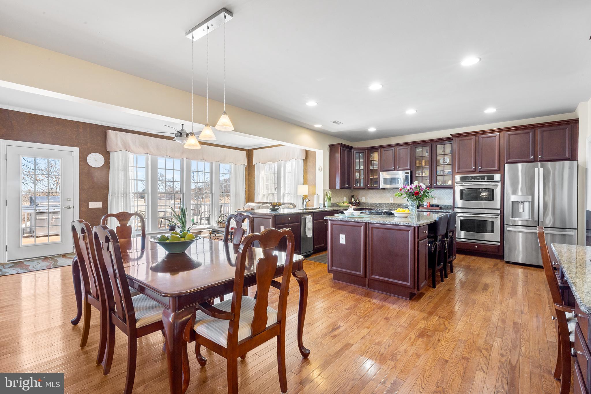 72 Hollow Drive Malvern, PA 19355 - Photo 7 of 63 a kitchen with a dining table chairs and refrigerator