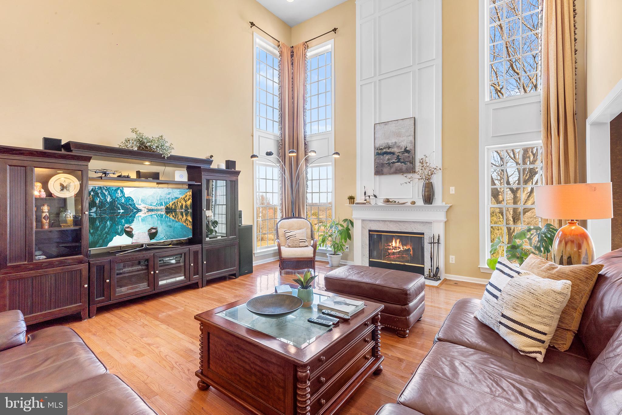 72 Hollow Drive Malvern, PA 19355 - Photo 8 of 63 a living room with furniture a flat screen tv and a fireplace
