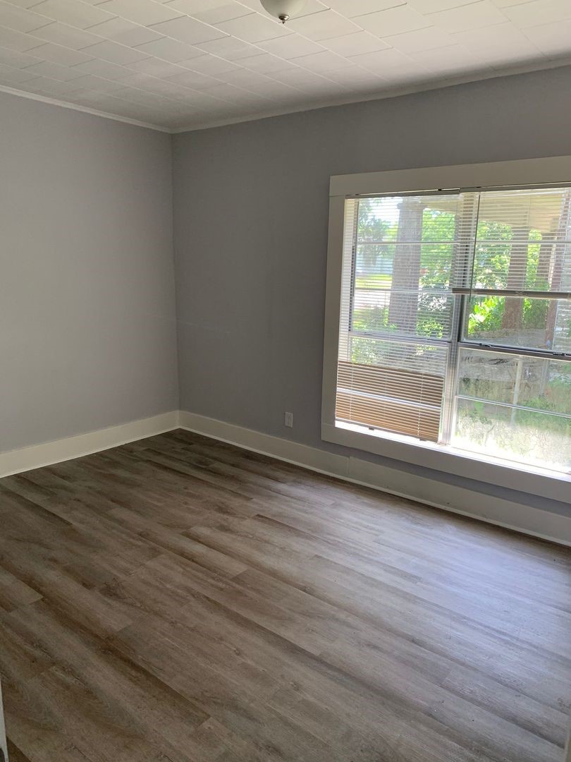 1409 10th Street Port Arthur, TX 77640 - Photo 8 of 11 a view of wooden floor and windows in a room