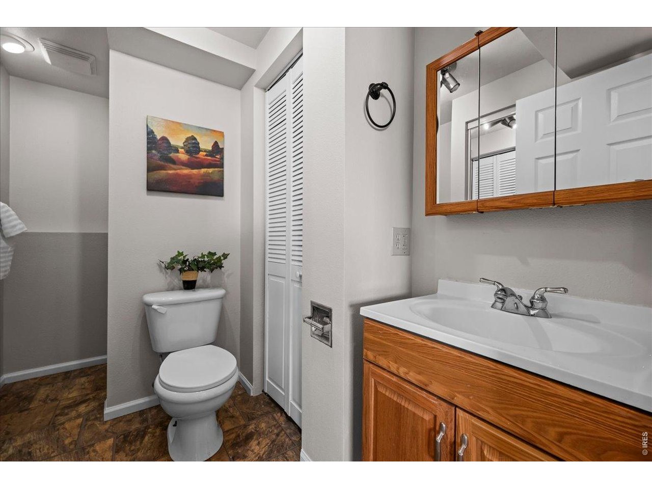 516 West Main Street Pierce, CO 80650 - Photo 17 of 24 a bathroom with a toilet a sink and mirror