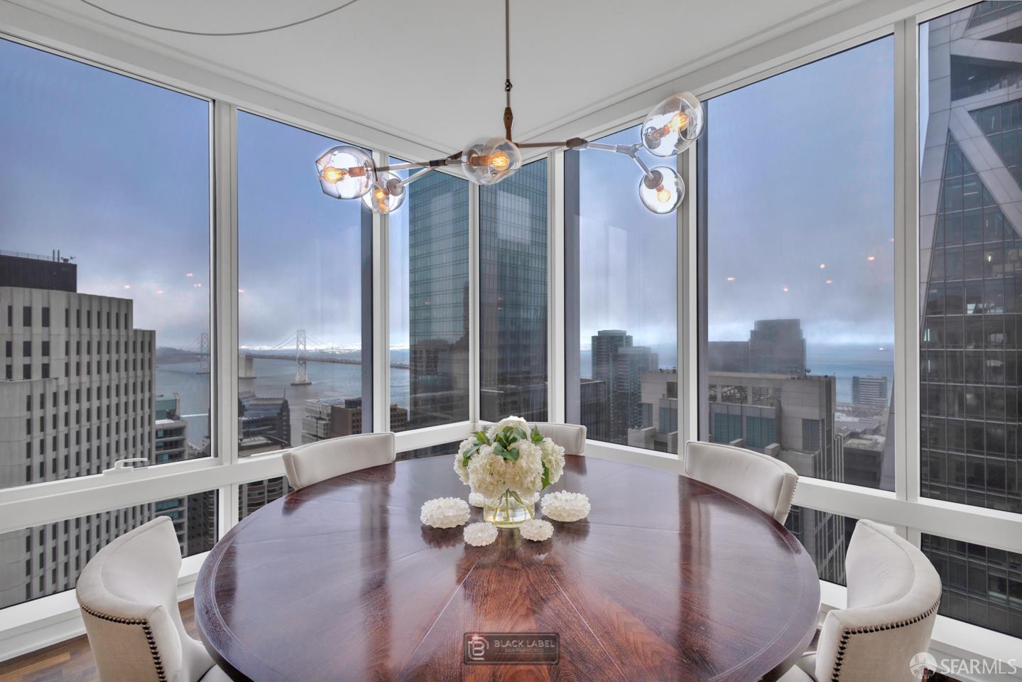 a dining room with furniture a chandelier and wooden floor