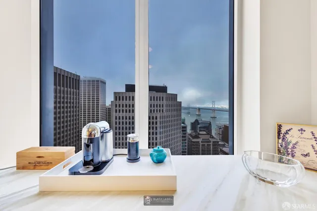 a kitchen with a sink dining table and chairs