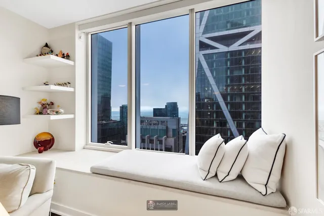 a bedroom with furniture and a large window