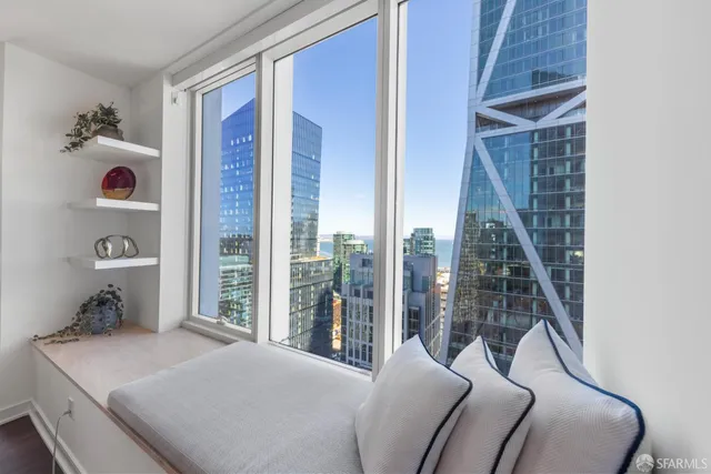 a bedroom with a bed and glass window