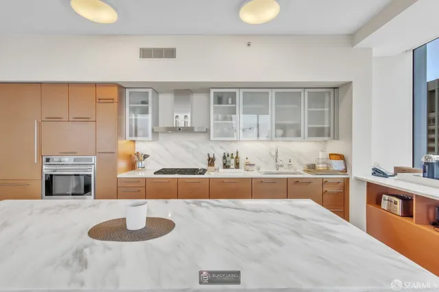 a large kitchen with kitchen island granite countertop a sink
