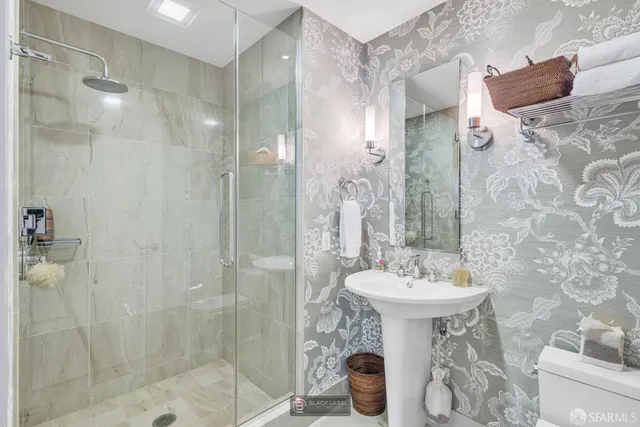 a bathroom with a tub sink and mirror