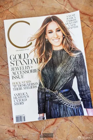 a view of living room with stainless steel appliances kitchen island granite countertop furniture and a fireplace