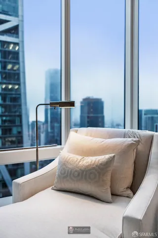 a spacious bedroom with a bed and a potted plant