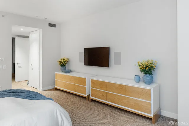 a view of a hallway with furniture and wooden floor