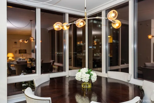 a living room with furniture and a chandelier